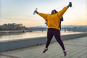 Woman in athletic gear leaps in the air